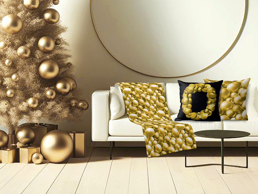 Gold Christmas blanket throw and pillow on a counch next to a Christmas tree